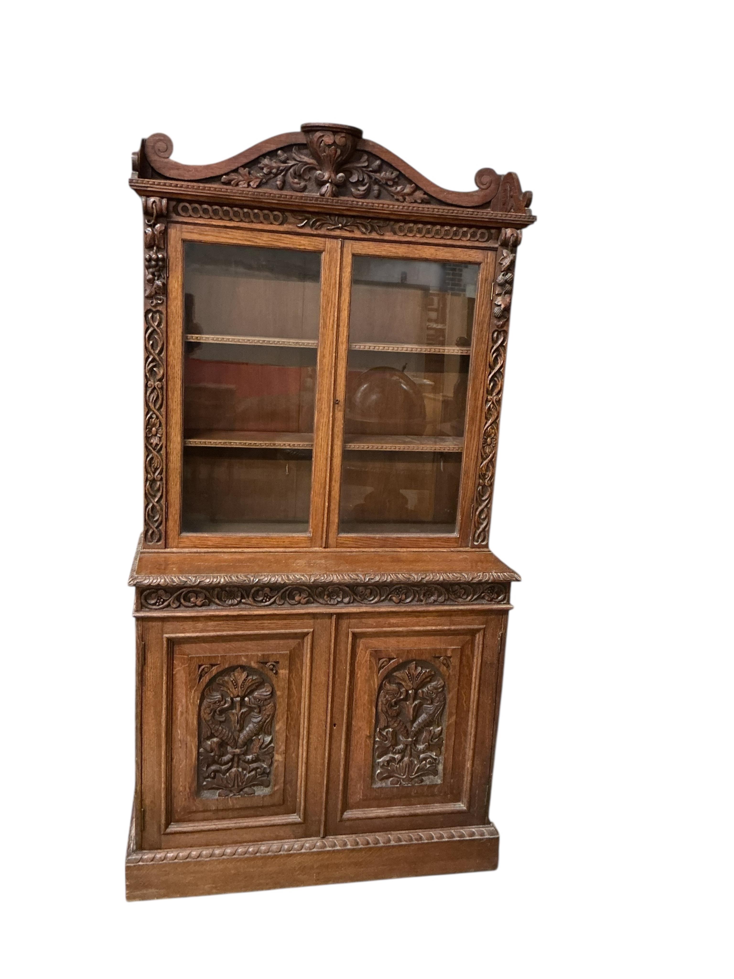 A late Victorian carved oak bookcase, width 90cm, depth 39cm, height 180cm